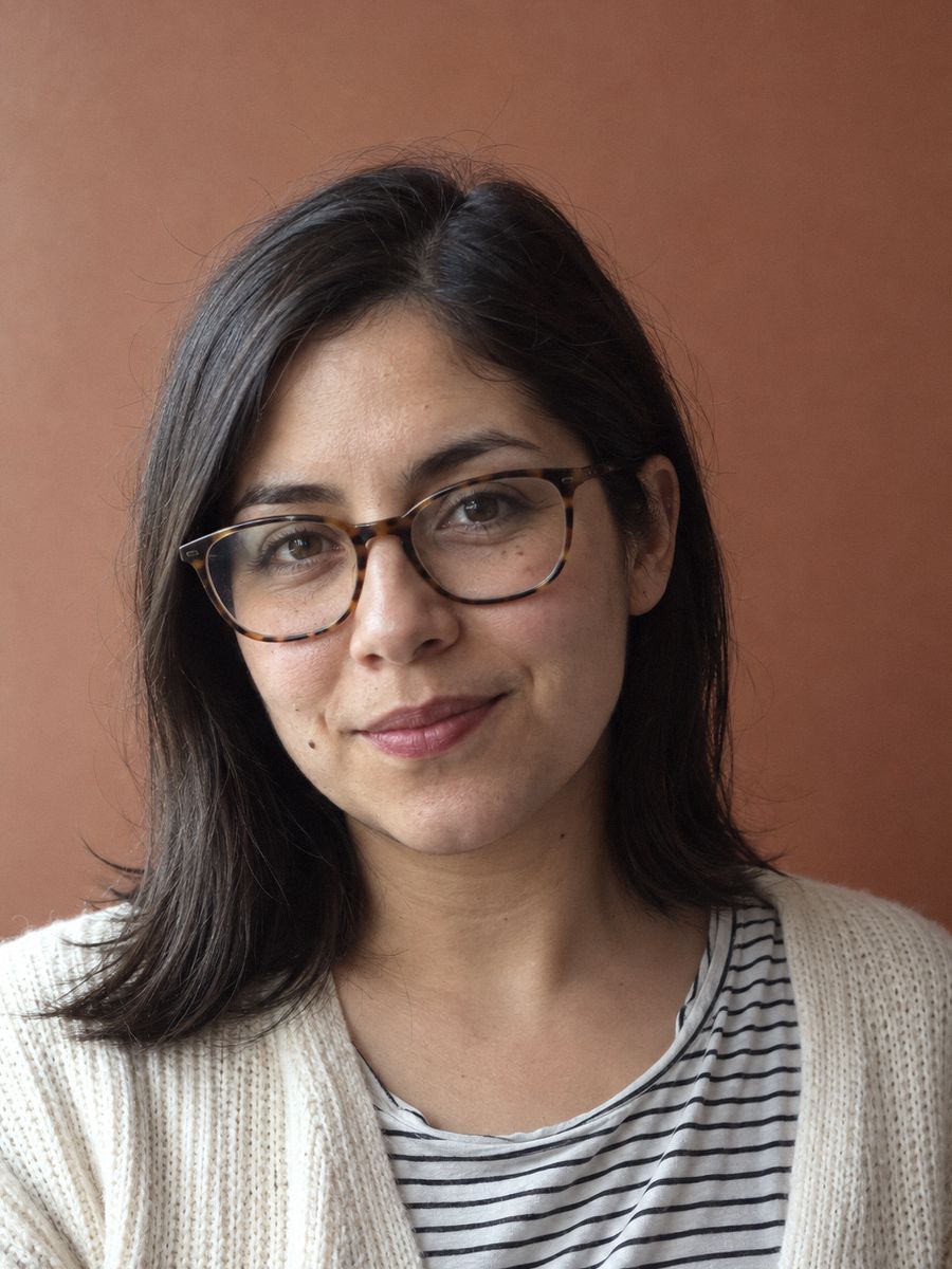 Camila, operations, in glasses and a cream cardigan